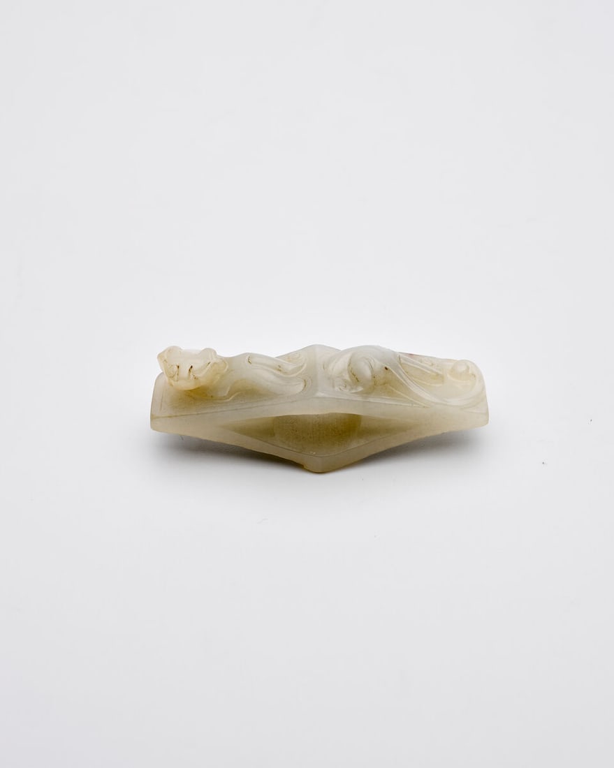 A PALE CELADON JADE 'CHI DRAGON' SWORD GUARD Han Dynasty style (1 of 4)