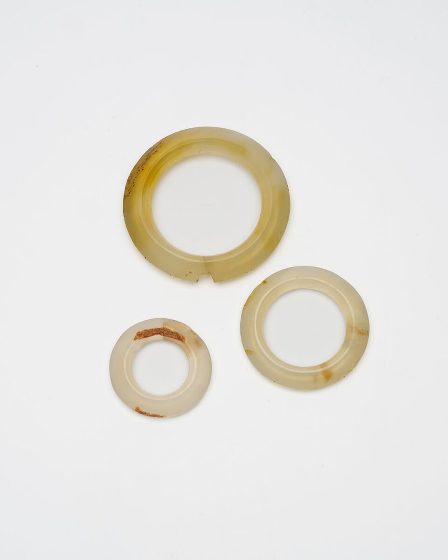 THREE AGATE RINGS Han Dynasty or later (3): THREE AGATE RINGS Han Dynasty or later Varying sizes from 3.8cm to 6.3cm diam. (3). Footnotes: 漢或以後 瑪瑙瑗三枚 For further information on this