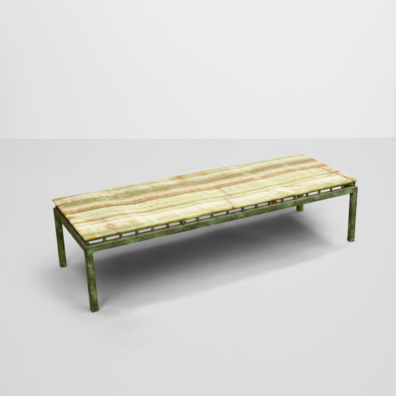 WILLIAM HAINES (1900-1973) Onyx Topped Coffee Tableonyx, patinated metalheight 15 1/4in (38.7cm)...: WILLIAM HAINES (1900-1973) Onyx Topped Coffee Table onyx, patinated metal height 15 1/4in (38.7cm); length 60 3/4in (154.3cm); width 21 3/4in (55.2cm) Footnotes: Provenance Billy Haines, Lorna Lane Re