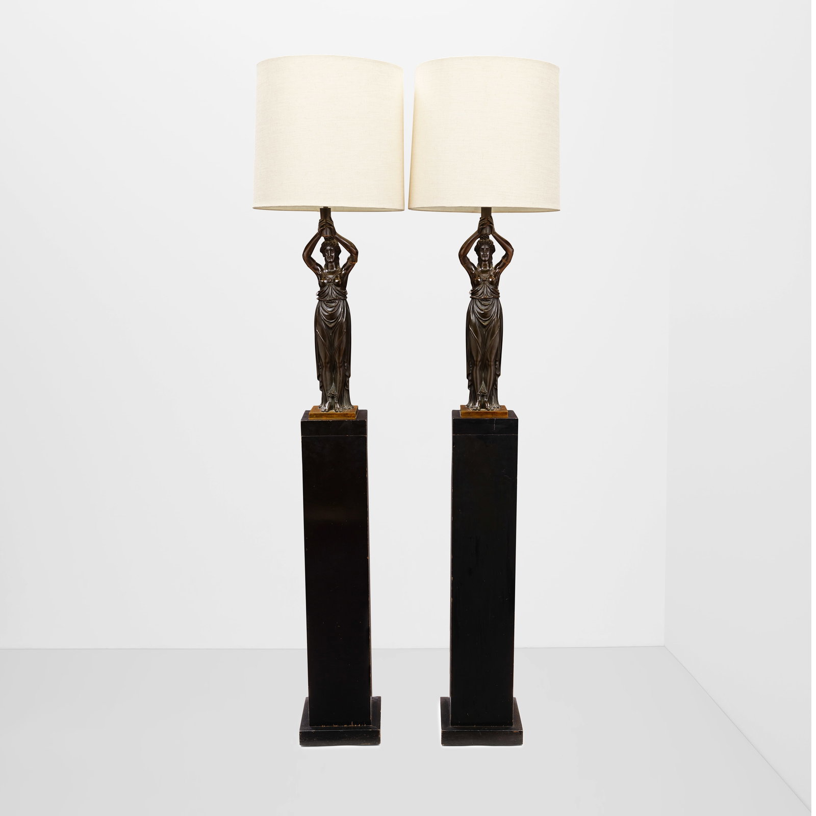WILLIAM HAINES (1900-1973) Pair of Bronze Greek Figure Floor Lampslacquered wood, bronze, linen ...: WILLIAM HAINES (1900-1973) Pair of Bronze Greek Figure Floor Lamps lacquered wood, bronze, linen upholstered shades height 71 1/2in (181.5cm); diameter of shade 14 1/2in (37cm) Footnotes: Provenance B