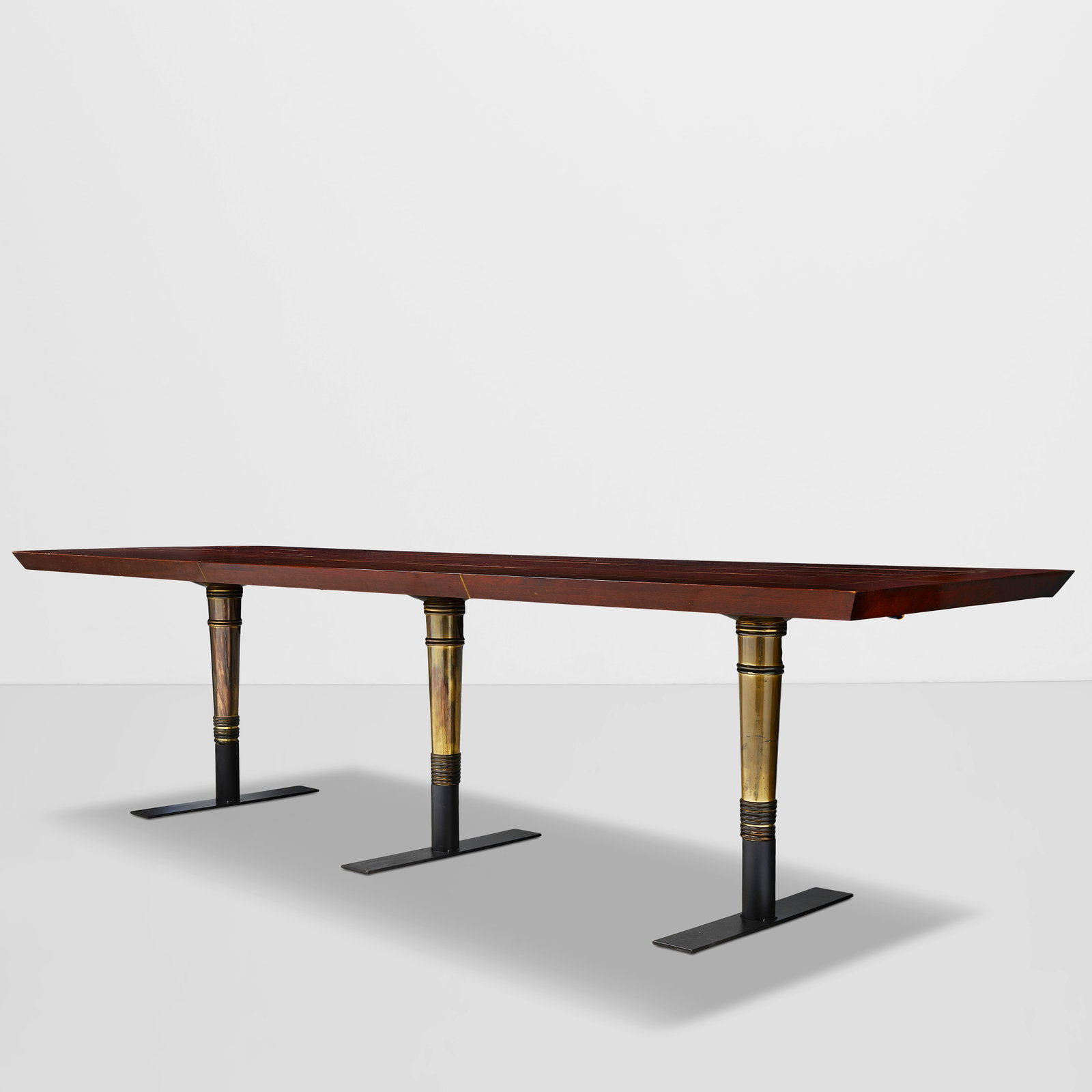 WILLIAM HAINES (1900-1973) The Lorna Lane Dining Tablepolished mahogany, brass inlay, brassheigh...: WILLIAM HAINES (1900-1973) The Lorna Lane Dining Table polished mahogany, brass inlay, brass height with legs sunk into floor 28 1/2in (72.5cm); width 144in (366cm); depth 42in (106.5cm); height with 