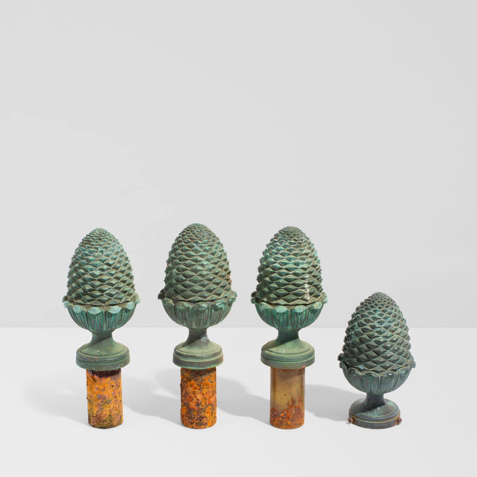 WILLIAM HAINES (1900-1973) Four Pinecone Finialspatinated cast bronzeheight 6 1/4in (15.8cm); di...: WILLIAM HAINES (1900-1973) Four Pinecone Finials patinated cast bronze height 6 1/4in (15.8cm); diameter 3 1/2in (8.8cm); height with mount 9 1/4in (23.5cm) Footnotes: Provenance Billy Haines, Lorna L
