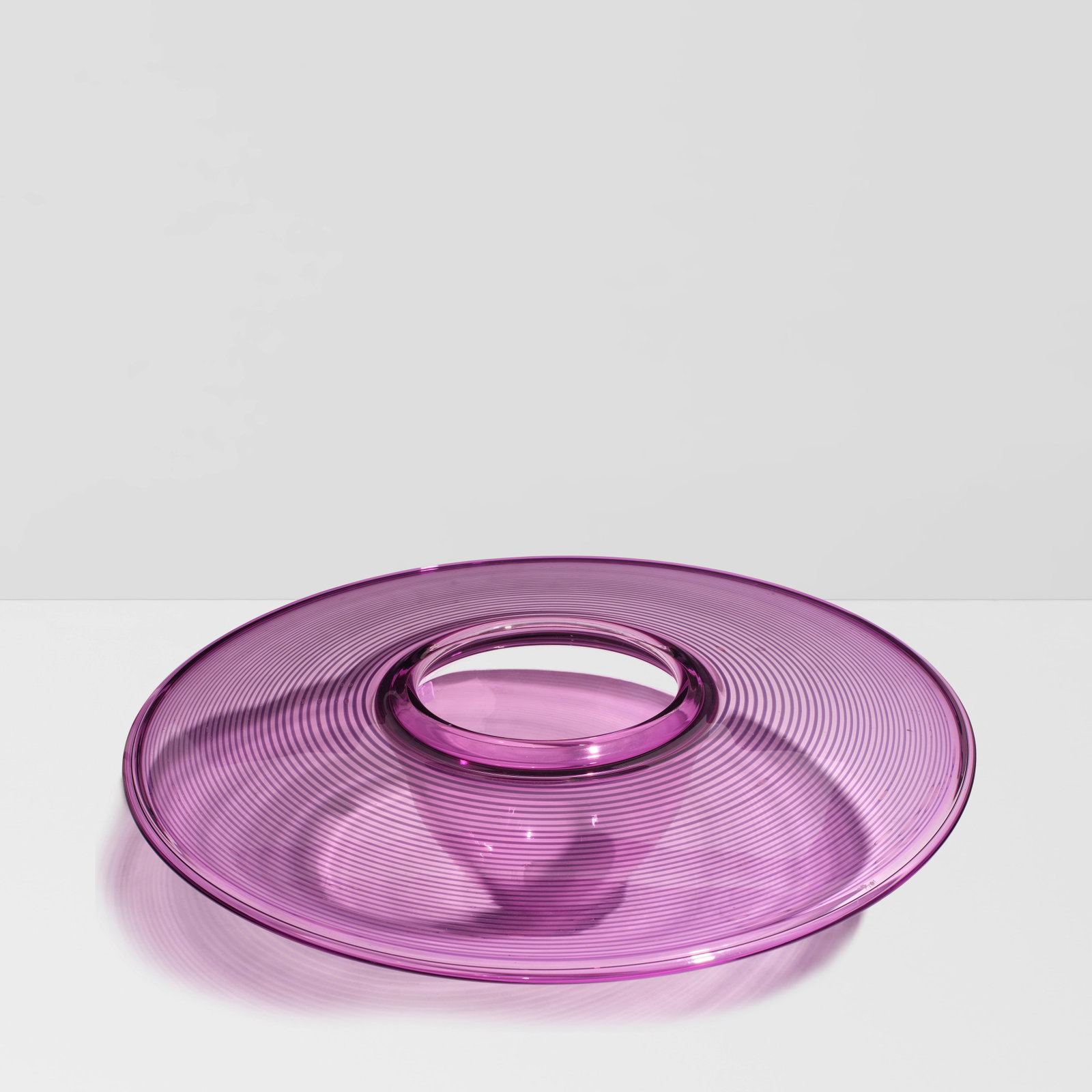 BENJAMIN MOORE (1952-2021) Amethyst Interior Fold1985blown glass, etched 'Benjamin Moore 1985 on...: BENJAMIN MOORE (1952-2021) Amethyst Interior Fold 1985 blown glass, etched 'Benjamin Moore 1985 on underside' height 5in (13cm); diameter 20in (51cm) For further information on this lot please visit B
