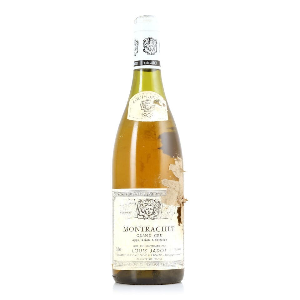 Louis Jadot, Montrachet, 1988 (1 x 750ml): Louis Jadot, Montrachet, 1988 (1 x 750ml) Region: Côte de Beaune Fill Level: 4cms Capsule: bin-soiled Label: bin-soiled, damp-stained with cardboard adhering; badly damp-affected vintage label Fo