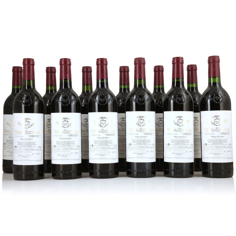 Vega Sicilia, Unico, 1990 (12 x 750ml): Vega Sicilia, Unico, 1990 (12 x 750ml) Region: Spain Capsule: 4 lightly corroded Label: very lightly damp-affected Packaging: original wooden case For further information on this lot please visit Bonh