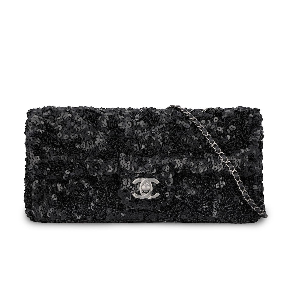 Chanel: a Black Sequin East West Flap Bag 2014-15 (includes serial sticker and dust bag): Chanel: a Black Sequin East West Flap Bag 2014-15 Creative Director: Karl Lagerfeld Silver tone hardware Condition Grade B 24cm wide, 12cm high, 4cm deep, 51cm shoulder drop, includes serial sticker a