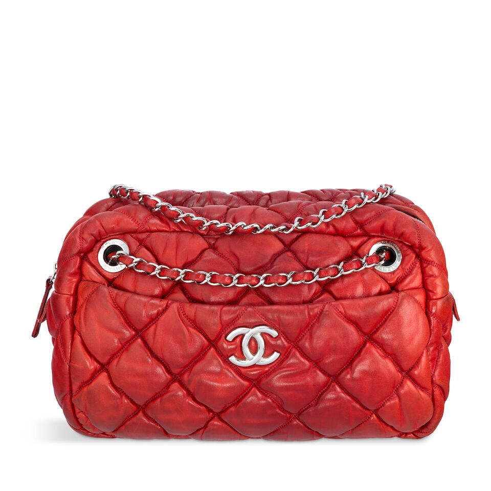 Chanel: a Red Bubble Quilt Camera Bag 2009-10 (includes serial sticker, authenticity card and du...: Chanel: a Red Bubble Quilt Camera Bag 2009-10 Creative Director: Karl Lagerfeld Padded red lambskin with silver tone hardware Condition Grade C- 26cm wide, 18cm high, 9cm deep, 28/53cm shoulder drop, 