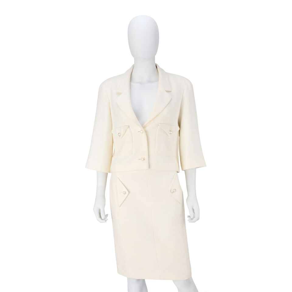 Chanel: a Cream Bouclé Wool Skirt Suit Spring 2012, Runway Look 1: Chanel: a Cream Bouclé Wool Skirt Suit Spring 2012, Runway Look 1 Creative Director: Karl Lagerfeld Comprising a cropped jacket with bracelet sleeves and a knee-length skirt, with hammered pearl-