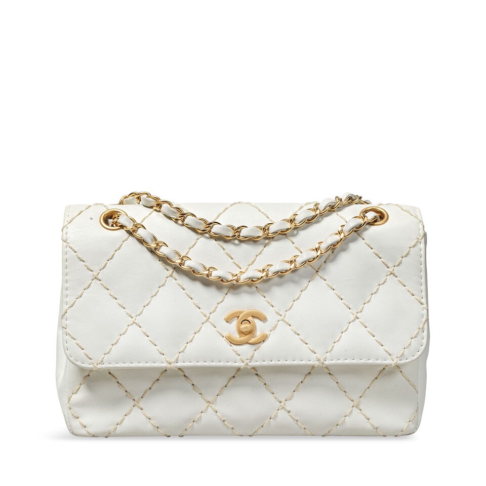 Chanel: a White Wild Stitch Single Flap Bag 2000-02 (includes serial sticker): Chanel: a White Wild Stitch Single Flap Bag 2000-02 Creative Director: Karl Lagerfeld White leather with beige stitched quilting, matte gold tone hardware Condition Grade B+ 26cm wide, 17cm high, 7cm 