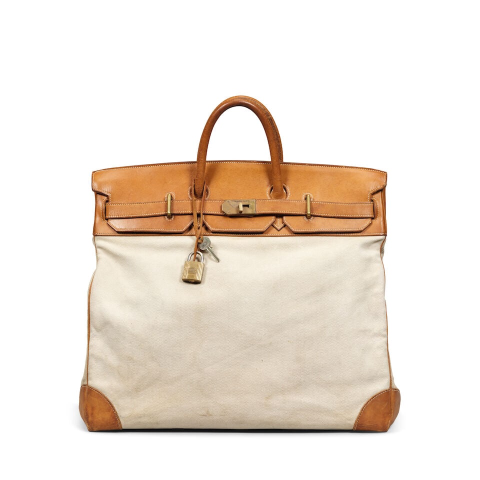Hermès: an Early Canvas and Leather Haut à Courroies HAC 50 Canvas and leather example...: Hermès: an Early Canvas and Leather Haut à Courroies HAC 50 Canvas and leather example introduced 1924 Tan leather with natural canvas body and brass hardware Condition Grade C- 50cm wide, 4