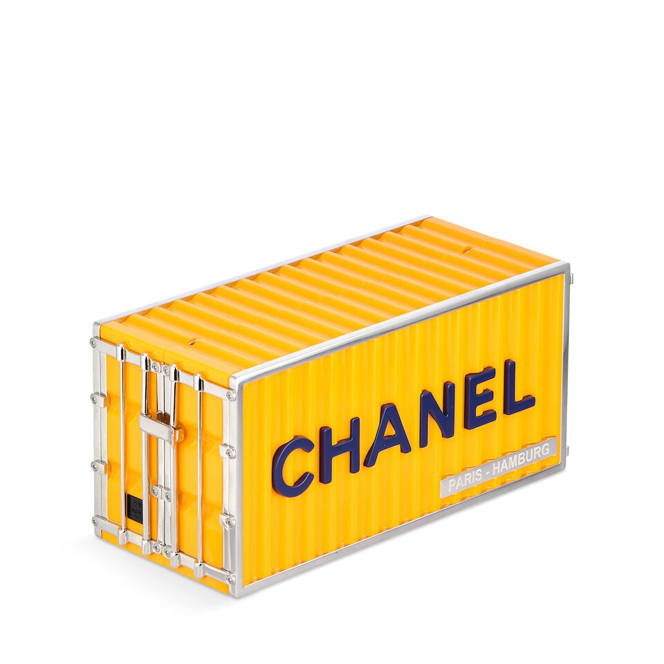 Chanel: a Yellow Lucite Shipping Container Minaudiere Paris-Hamburg Métiers d'Art Collectio...: Chanel: a Yellow Lucite Shipping Container Minaudiere Paris-Hamburg Métiers d'Art Collection, Pre-Fall 2018, Runway Look 34 Creative Director: Karl Lagerfeld Apricot yellow ridged Lucite with blu