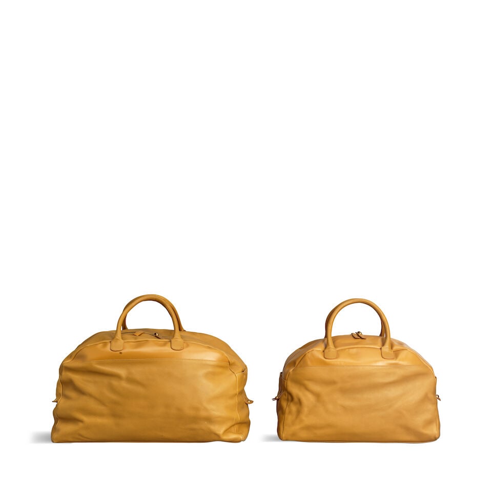 Loewe: a Set of Two Mustard Yellow Leather Travel Bags 1990s (both with shoulder straps and dust... (1 of 2)