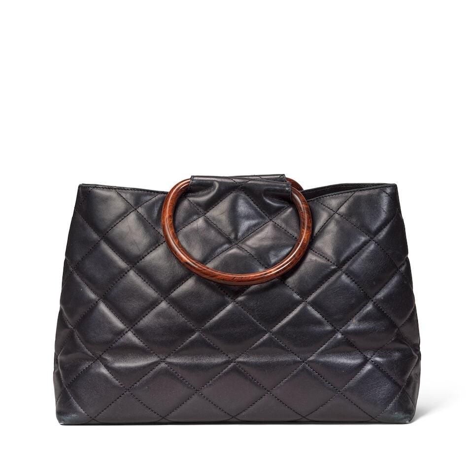 Chanel: a Black Lambskin Tote with Wood-Effect Handles 2000-02 (includes serial sticker, authent...: Chanel: a Black Lambskin Tote with Wood-Effect Handles 2000-02 Creative Director: Karl Lagerfeld Smooth black lambskin with burled wood-effect resin handles and CC motif Condition Grade B- 35cm wide, 