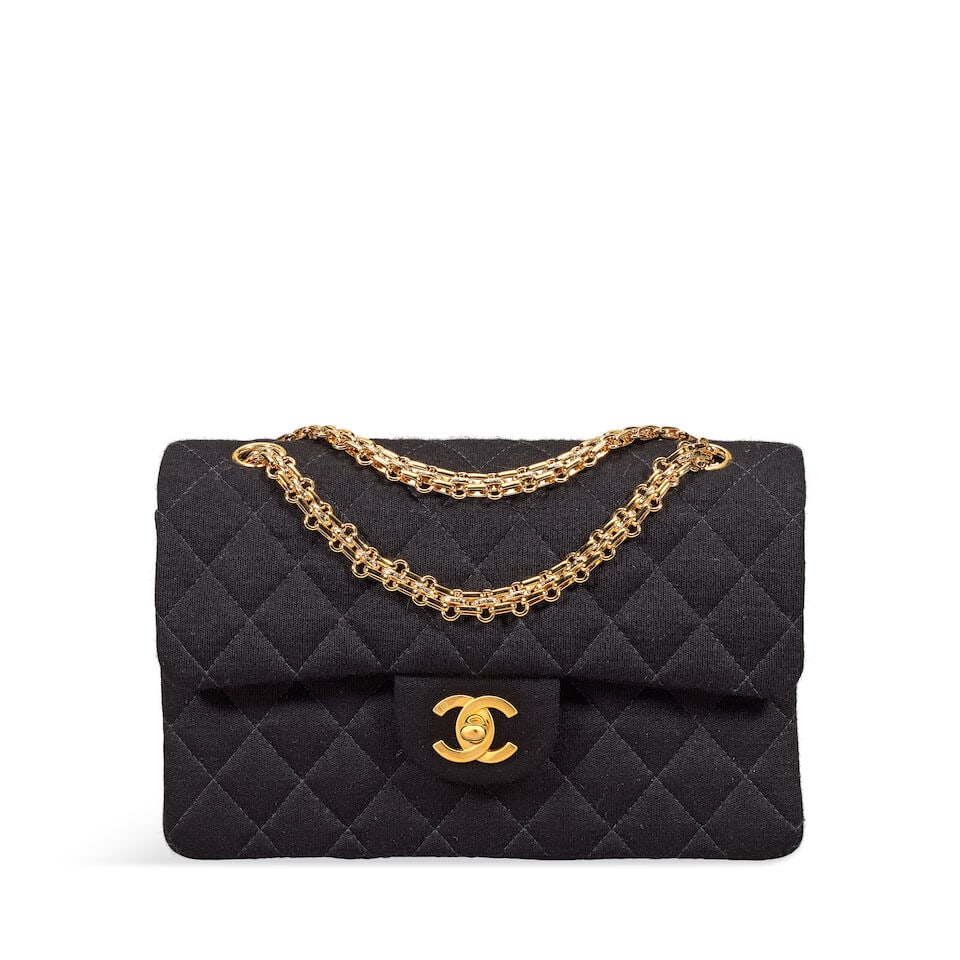Chanel: a Small Black Jersey Classic Flap Bag 2000-02 (includes serial sticker, authenticity car...: Chanel: a Small Black Jersey Classic Flap Bag 2000-02 Creative Director: Karl Lagerfeld Quilted black jersey with gold tone hardware and chain shoulder strap Condition Grade A 22.5cm wide, 15cm high, 