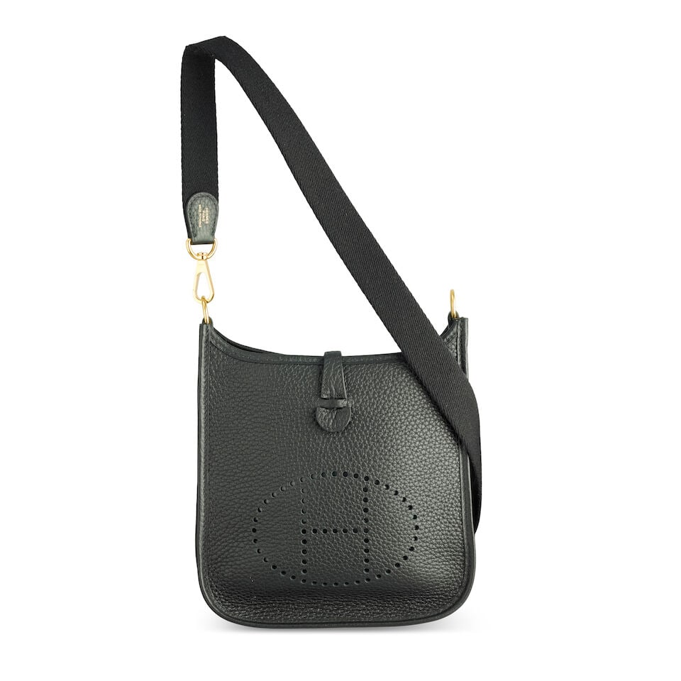 Hermès: a Black Clemence Leather Evelyne TPM 16 2023 (includes dust bags, care card and box): Hermès: a Black Clemence Leather Evelyne TPM 16 2023 Gold tone hardware Condition Grade B+ 16cm wide, 18cm high, 55cm shoulder drop, includes dust bags, care card and box For further information 