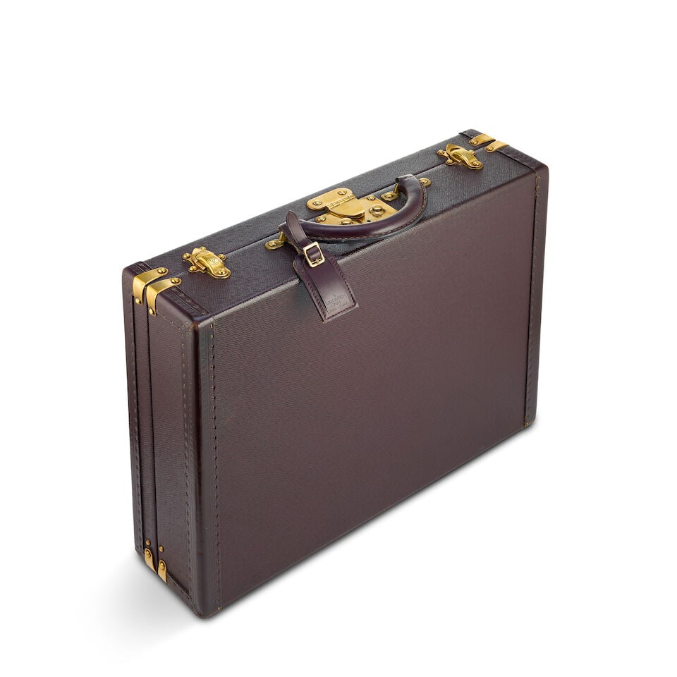 Louis Vuitton: a Purple Taiga President Briefcase (includes luggage tag): Louis Vuitton: a Purple Taiga President Briefcase Textured leather with brass hardware Condition Grade C+ 45cm wide, 35cm deep, 12cm high, includes luggage tag For further information on this lot plea