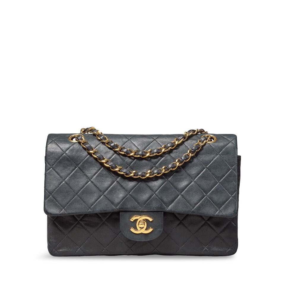 Chanel: a Black Lambskin Medium Classic Flap Bag early 1980s, pre-serialisation: Chanel: a Black Lambskin Medium Classic Flap Bag early 1980s, pre-serialisation Creative Director: Karl Lagerfeld Quilted lambskin with gold tone hardware Condition Grade C 25cm wide, 15cm high, 2.5cm