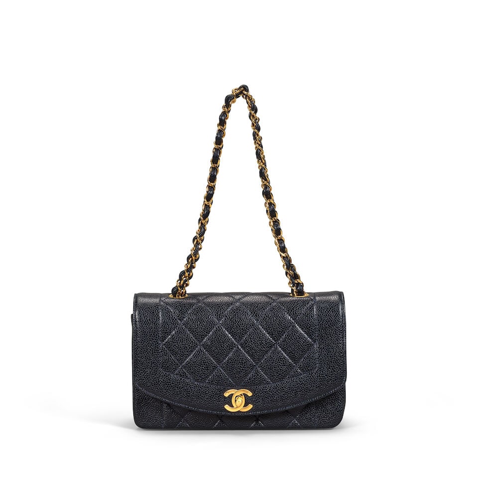 Chanel: a French Navy Caviar Leather Small Diana Bag 1990s (date code illegible) (includes dust ...: Chanel: a French Navy Caviar Leather Small Diana Bag 1990s (date code illegible) Creative Director: Karl Lagerfeld Quilted Caviar leather with gold tone hardware Condition Grade C+ 22cm wide, 14cm hig
