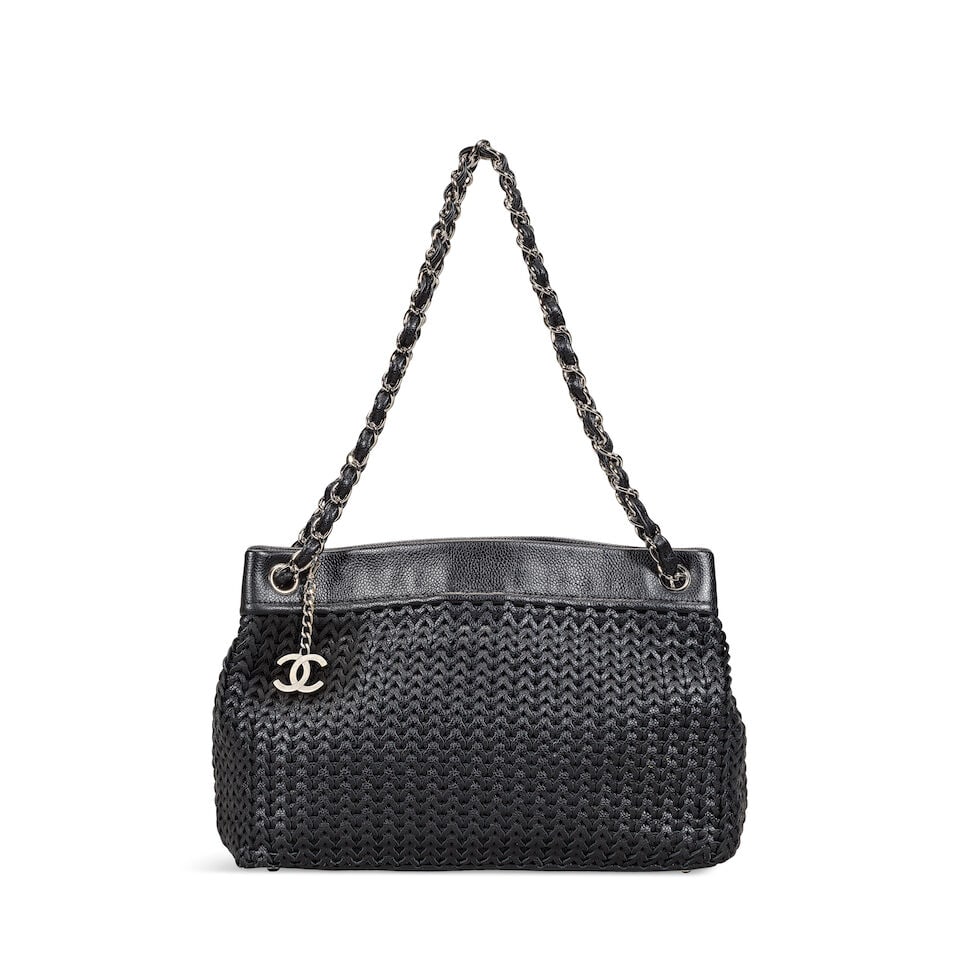 Chanel: a Black Woven Caviar Leather Shoulder Tote 2004-05 (includes serial sticker and dust bag): Chanel: a Black Woven Caviar Leather Shoulder Tote 2004-05 Creative Director: Karl Lagerfeld Woven body formed of caviar leather chains, silver tone hardware with CC charm feature Condition Grade A- 3