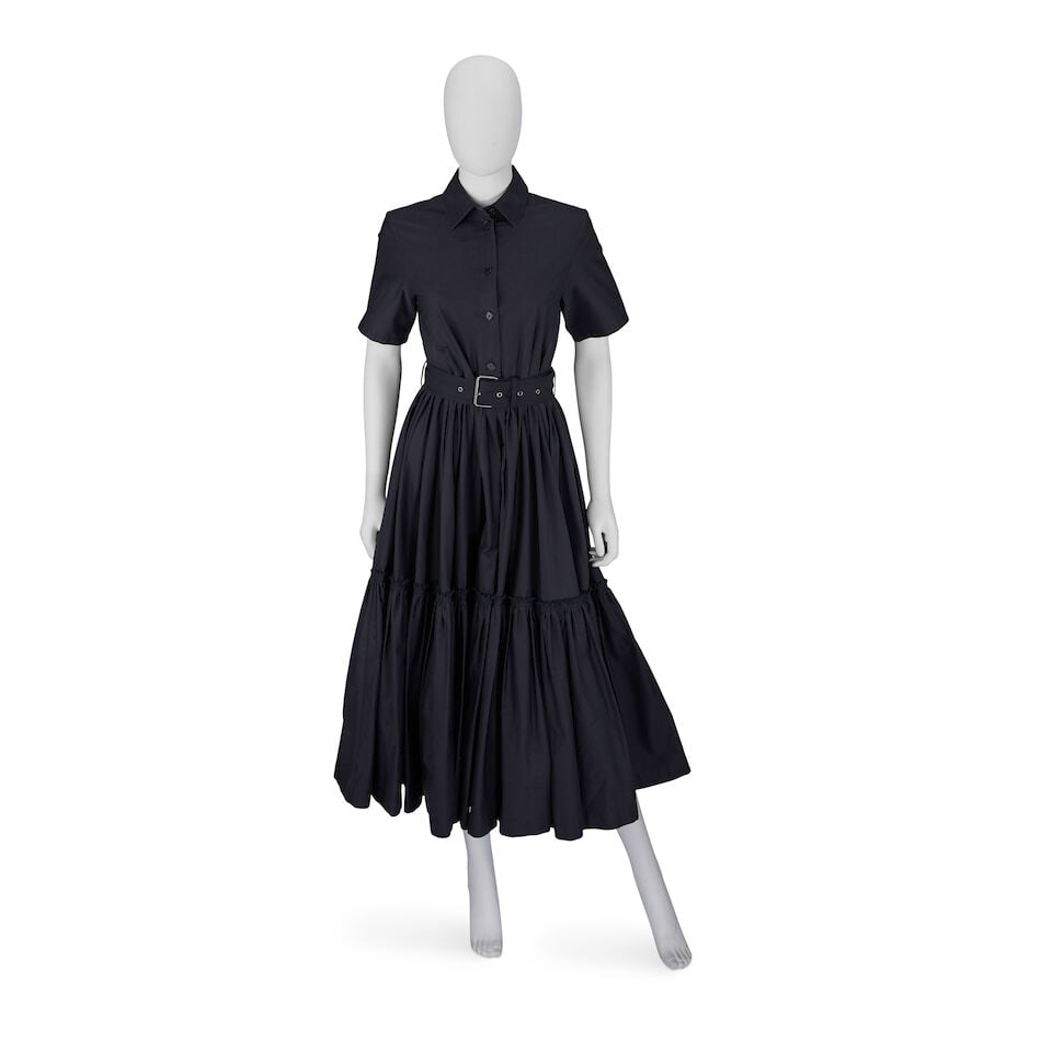 Christian Dior: a Black Cotton Tiered Dress: Christian Dior: a Black Cotton Tiered Dress Creative Director: Maria Grazia Chiuri Mid-calf length with full skirt and belted waist with silver tone buckle Condition Grade A- Labelled size 34 (UK size