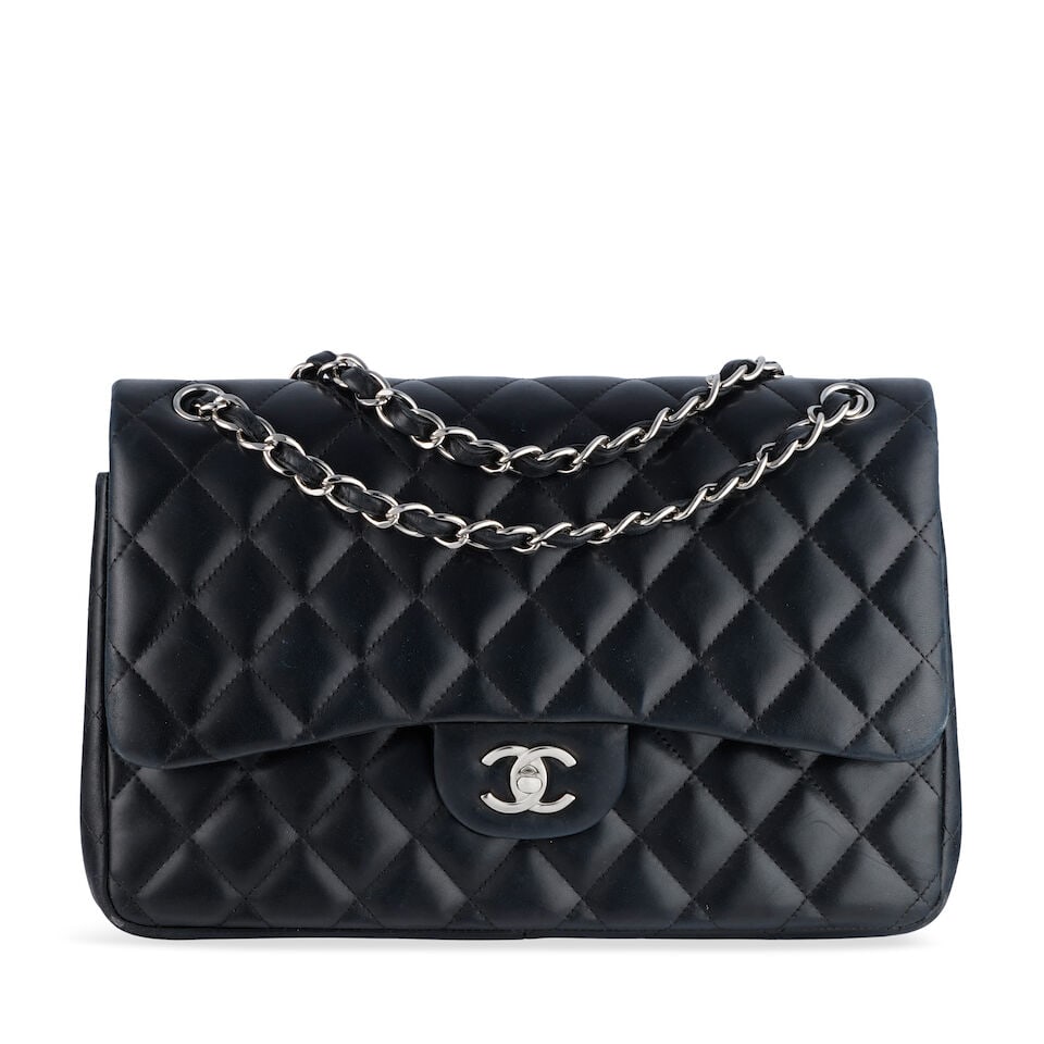 Chanel: a Black Lambskin Leather Jumbo Double Flap Bag 2012 (includes serial sticker): Chanel: a Black Lambskin Leather Jumbo Double Flap Bag 2012 Creative Director: Karl Lagerfeld Quilted lambskin leather with silver tone hardware Condition Grade B- 30cm wide, 21cm high, 9cm deep, 34/6