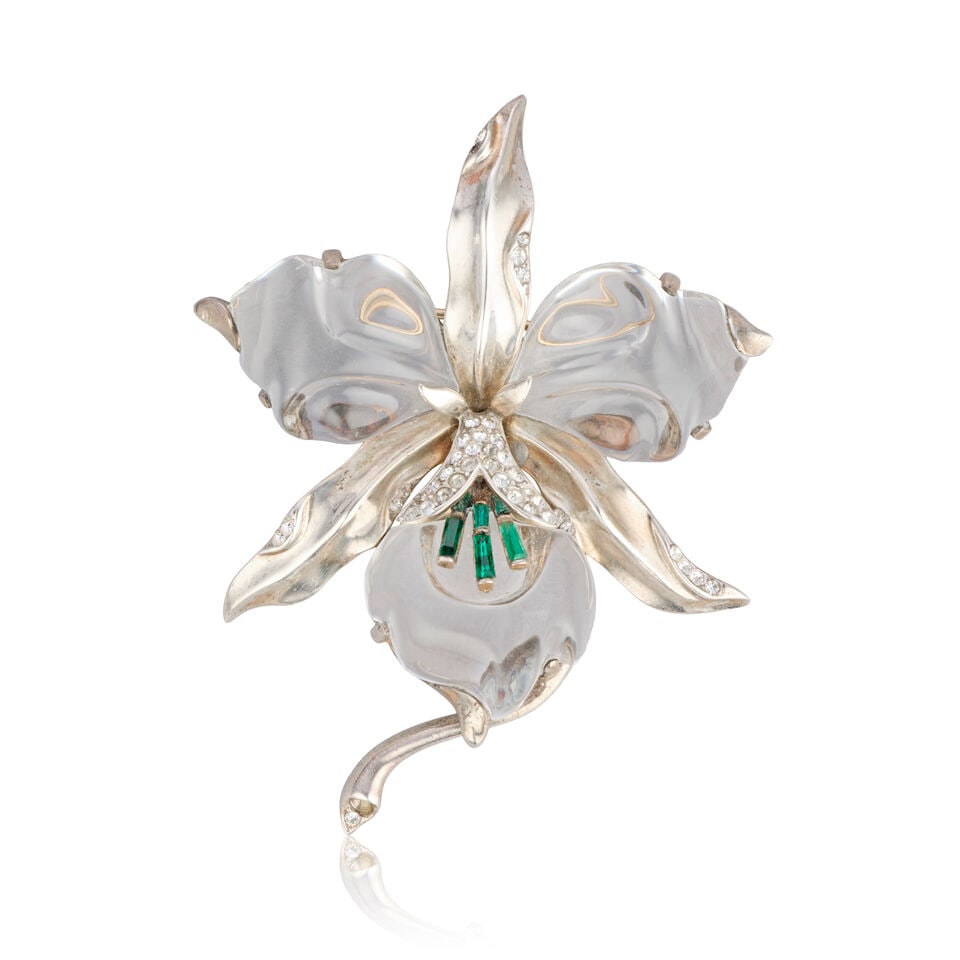 Trifari: a Sterling Silver Orchid Jelly Belly Pin Brooch c.1944: Trifari: a Sterling Silver Orchid Jelly Belly Pin Brooch c.1944 Brooch in the shape of an orchid flower, decorated with green baguette-cut glass stones and rhinestones, Crown Trifari signature, Patent