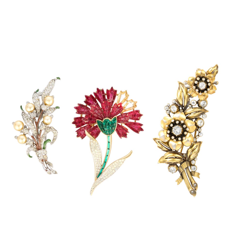 Trifari: Three Flower Pin Brooches: Trifari: Three Flower Pin Brooches To include an 'invisible-set' carnation flower pin brooch, c.1961, 5cm wide, 8cm high, a simulated pearl flower fur pin, late 1930s-early 1940s, 3cm wide, 7cm high, 