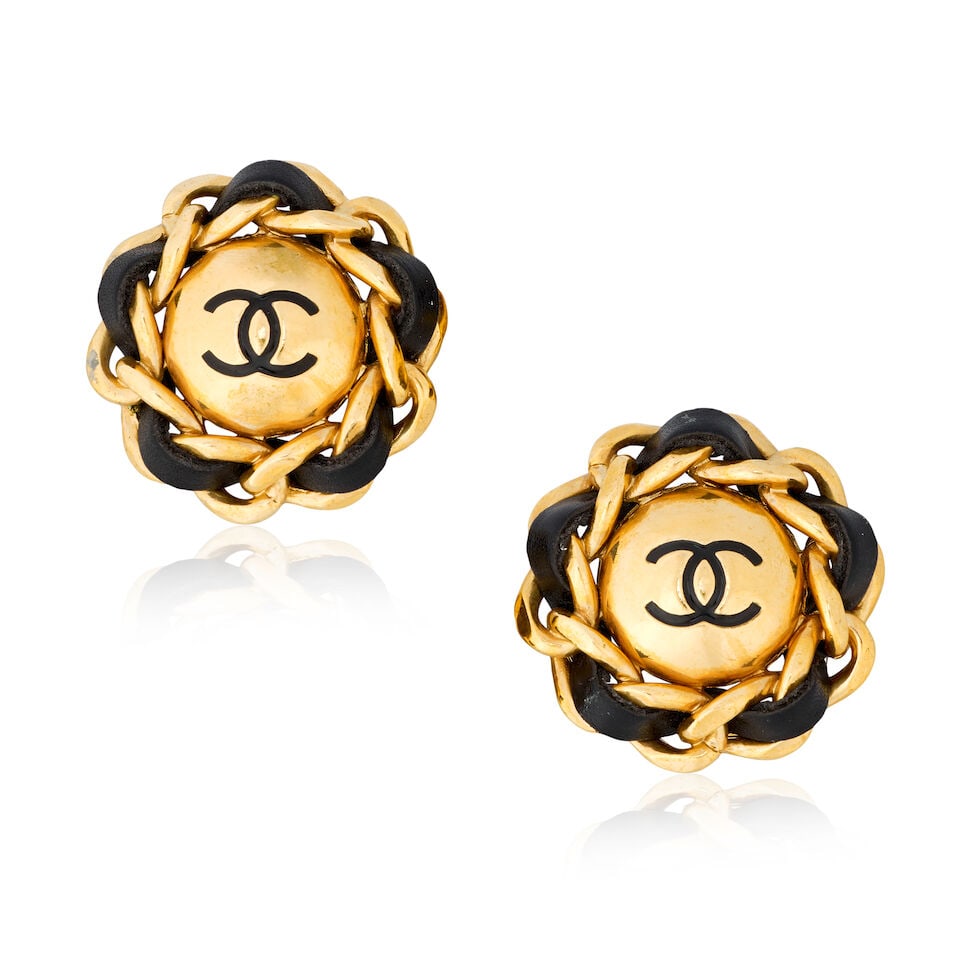 Chanel: a Pair of Gilt CC and Leather Clip Earrings Autumn 1993: Chanel: a Pair of Gilt CC and Leather Clip Earrings Autumn 1993 Creative Director: Karl Lagerfeld Large gilt CC earrings with lambskin-threaded chain surrounds Condition Grade B+ Approximately 4.5cm d