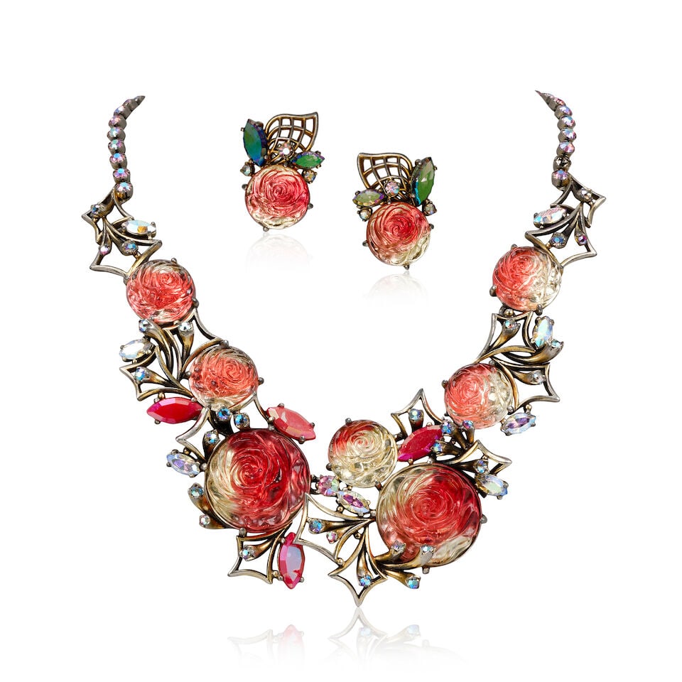 Elsa Schiaparelli: a Molten Glass Briar Rose Necklace Suite 1950s: Elsa Schiaparelli: a Molten Glass Briar Rose Necklace Suite 1950s Pink ombre glass stylised roses with gilt briar design, necklace 25cm drop, and matching clip earrings, 3.7cm high (2) Condition Grade