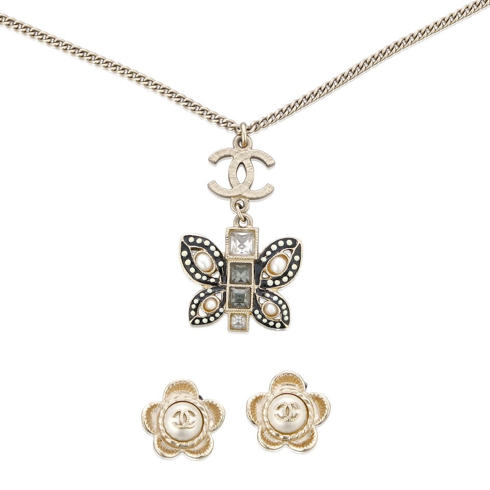 Chanel: a Butterfly Pendant Necklace and a Pair of Earrings Cruise 2016: Chanel: a Butterfly Pendant Necklace and a Pair of Earrings Cruise 2016 Creative Director: Karl Lagerfeld Champagne gold tone metal, the necklace with enamelled butterfly pendant with smoky quartz cry