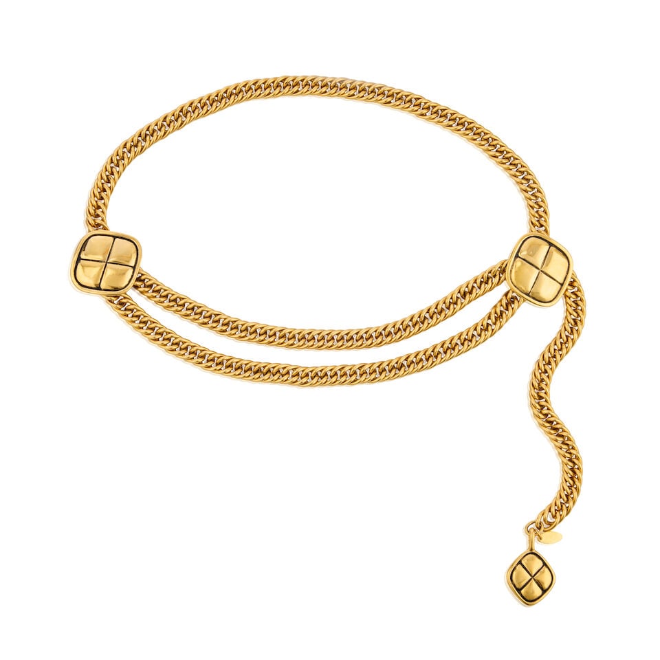 Chanel: a Gilt Metal Quilted Swag Belt 1980s (includes box): Chanel: a Gilt Metal Quilted Swag Belt 1980s Creative Director: Karl Lagerfeld Gold tone chain with quilted diamond shaped pendants Condition Grade A- 66cm maximum waist, includes box For further info