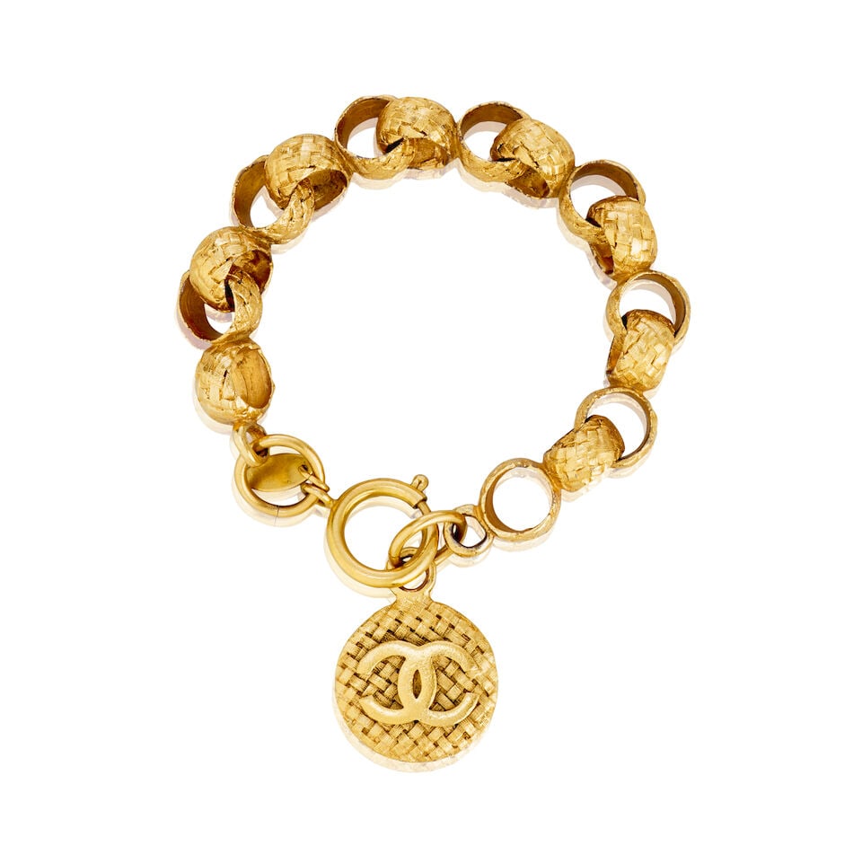 Chanel: a Gilt Textured Coin Chain Bracelet Collection 29, Autumn 1992: Chanel: a Gilt Textured Coin Chain Bracelet Collection 29, Autumn 1992 Creative Director: Victoire de Castellane Chain bracelet with woven textured CC medallion coin Condition Grade B+ Fits wrist 17-2