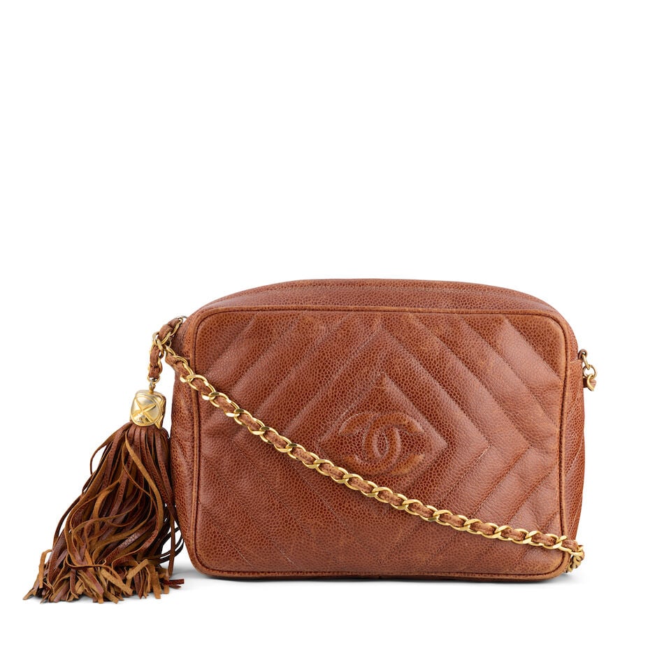 Chanel: a Brown Caviar Leather Camera Bag 1991-94 (includes serial sticker): Chanel: a Brown Caviar Leather Camera Bag 1991-94 Creative Director: Karl Lagerfeld Quilted caviar leather with gold tone hardware and tassel zip pull Condition Grade C+ 22.5cm wide, 16cm high, 6cm de