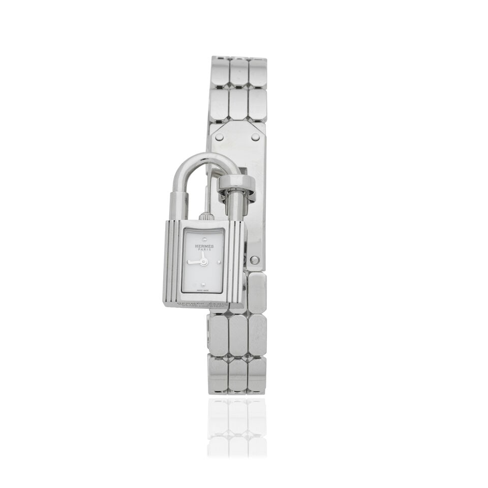 Hermès: a Stainless Steel Quartz Kelly Wristwatch in Mini Model Purchased 2026 (includes in...: Hermès: a Stainless Steel Quartz Kelly Wristwatch in Mini Model Purchased 2026 Spangled, white-lacquered dial, detachable padlock watch convertible for wear as a necklace, lanyard in black Box le