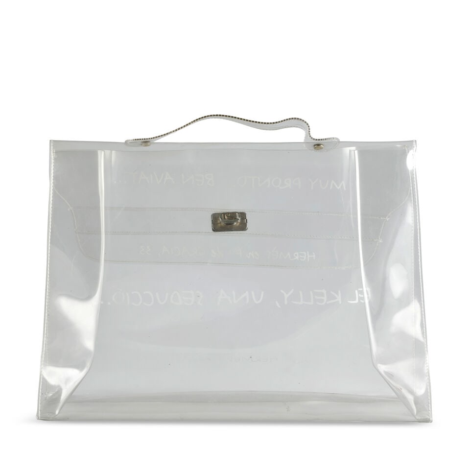 Hermès: a Vinyl Souvenir de L'Exposition Kelly Bag 1999: Hermès: a Vinyl Souvenir de L'Exposition Kelly Bag 1999 Clear plastic with white lettering and gold tone hardware Condition Grade C 40cm wide, 28cm high, 10cm deep Lot to be sold without reserve.