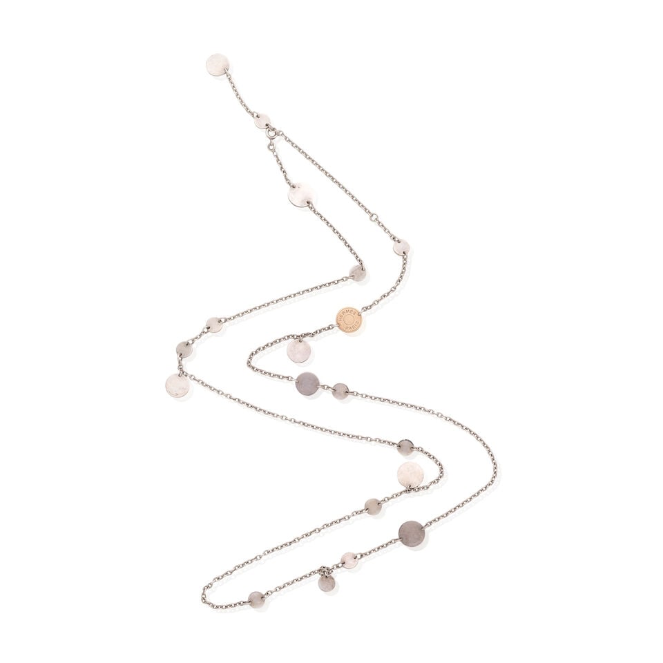 Hermès: a Silver Tone and Rose Gold Confetti Necklace: Hermès: a Silver Tone and Rose Gold Confetti Necklace Silver tone chain with discs and a single rose gold Clou de Selle charm, stamped '750' Condition Grade B 40cm drop For further information