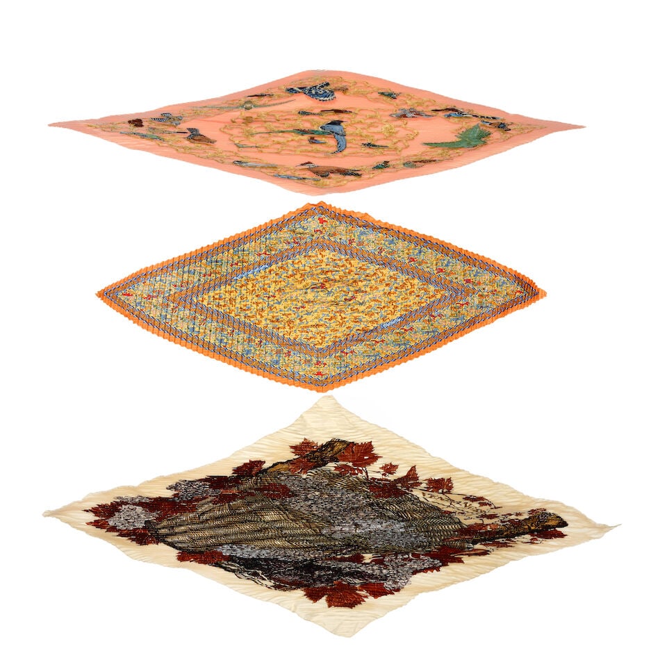 Hermès: Three Silk Plissé Scarves (includes one booklet and three boxes): Hermès: Three Silk Plissé Scarves Includes a peach ground 'Oiseaux de l'Inde et de L'Himalaya' example designed in 2001 by Catherine Baschet, a double plissé 'Chasse en Inde' example, d