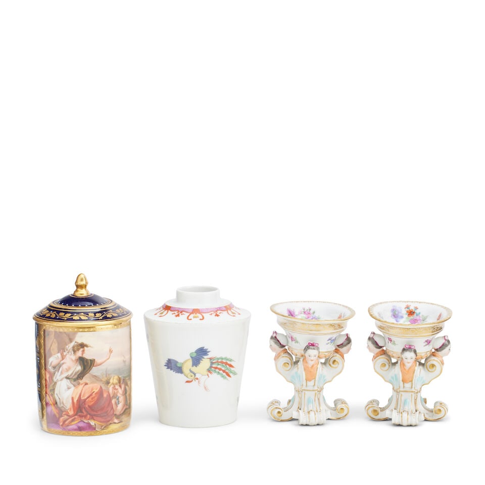 A Vienna style mug Blue shield mark, 19th century: A Vienna style mug Blue shield mark, 19th century Painted with a scene of Ariadne on a panel against a tooled blue ground with raised gilt dots, angular handle and domed cover with acorn finial, 12.2c