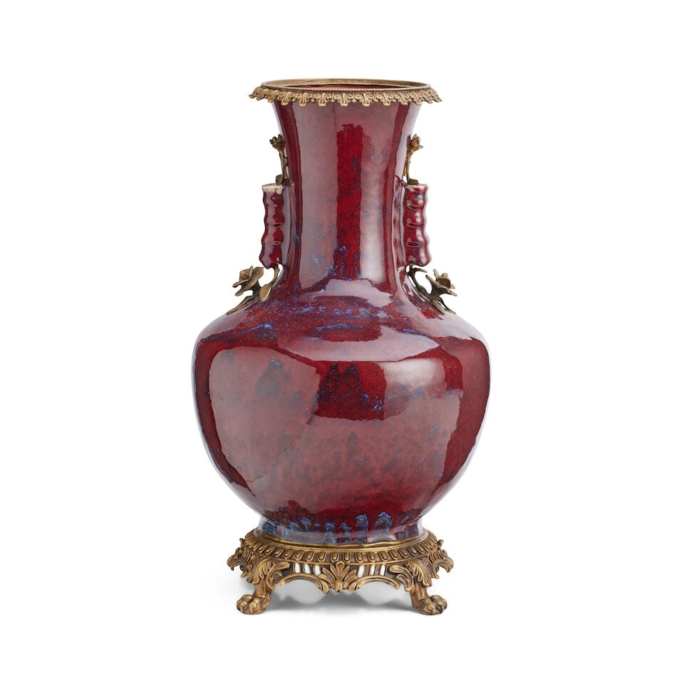 A large Chinese sang de beouf flambe arrow vase 19th century: A large Chinese sang de beouf flambe arrow vase 19th century Of baluster form with dark red and lavender running glaze, the neck with double ribbed cylindrical arrow handles, with twentieth century gi