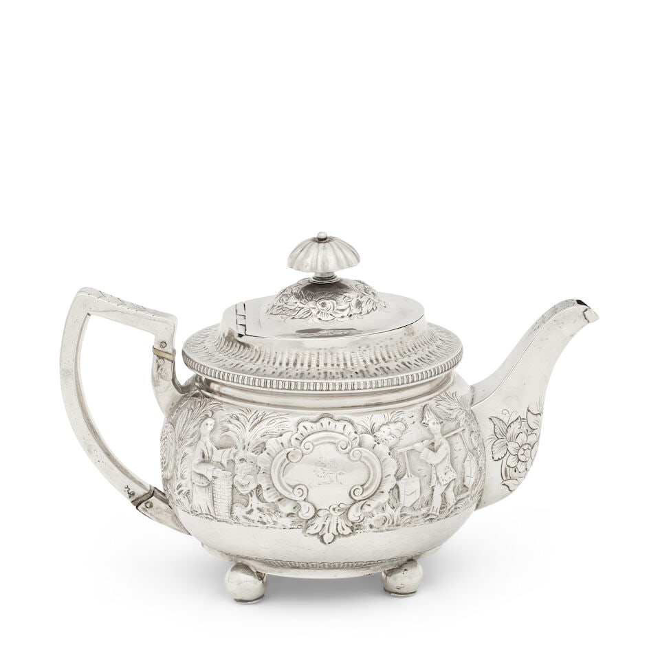A George III Irish silver teapot maker's mark mis-struck, Dublin, 1812: A George III Irish silver teapot maker's mark mis-struck, Dublin, 1812 Broad bellied circular form on four ball feet and later decorated, embossed to each side with Chinese figures centred by a rococo