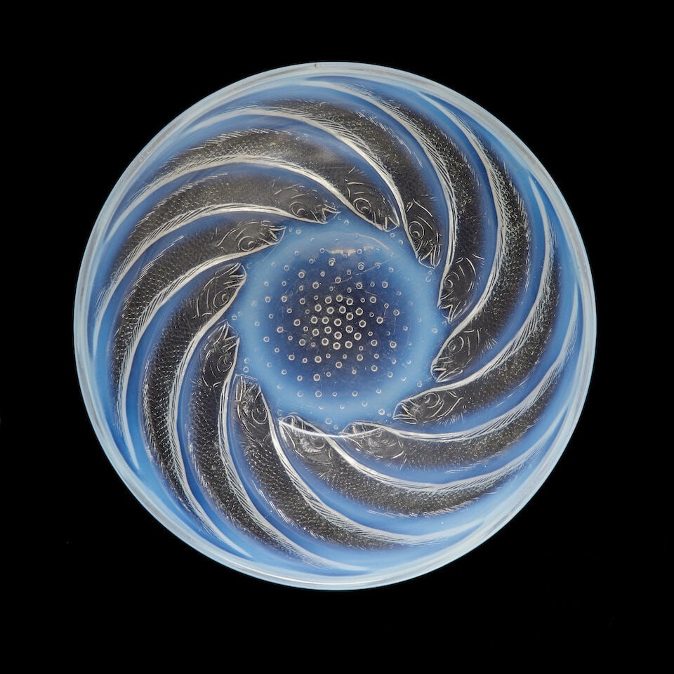 A Lalique 'Poissons' bowl no.1 Designed 1921: A Lalique 'Poissons' bowl no.1 Designed 1921 Opalescent and moulded on the exterior with swirling fish in spiral formation around an air bubble ground, 23.8cm diameter moulded mark 'R. LALIQUE' Footno