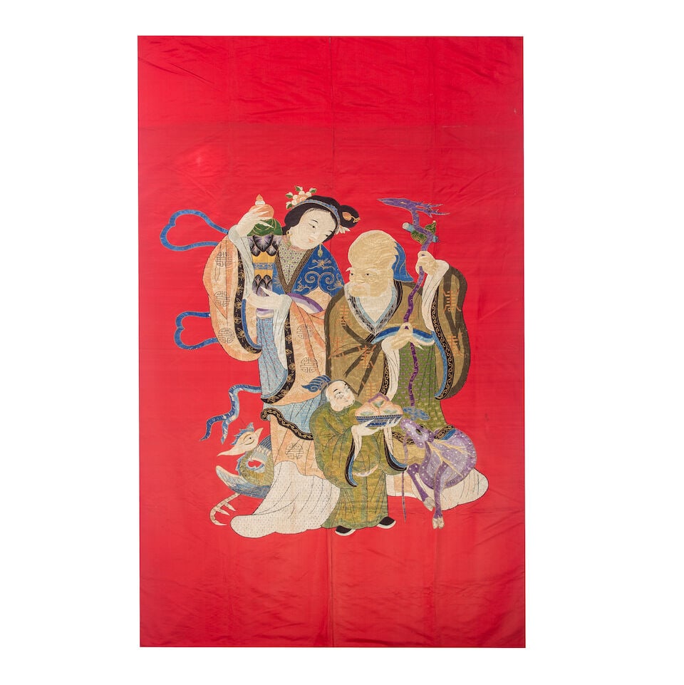 A Chinese silk embroidery late 19th/early 20th century: A Chinese silk embroidery late 19th/early 20th century On a red silk ground embordered figure of Shoulao, his head padded and raised in low relief, with attendants deer and crane, 149cm x 267 Footnote