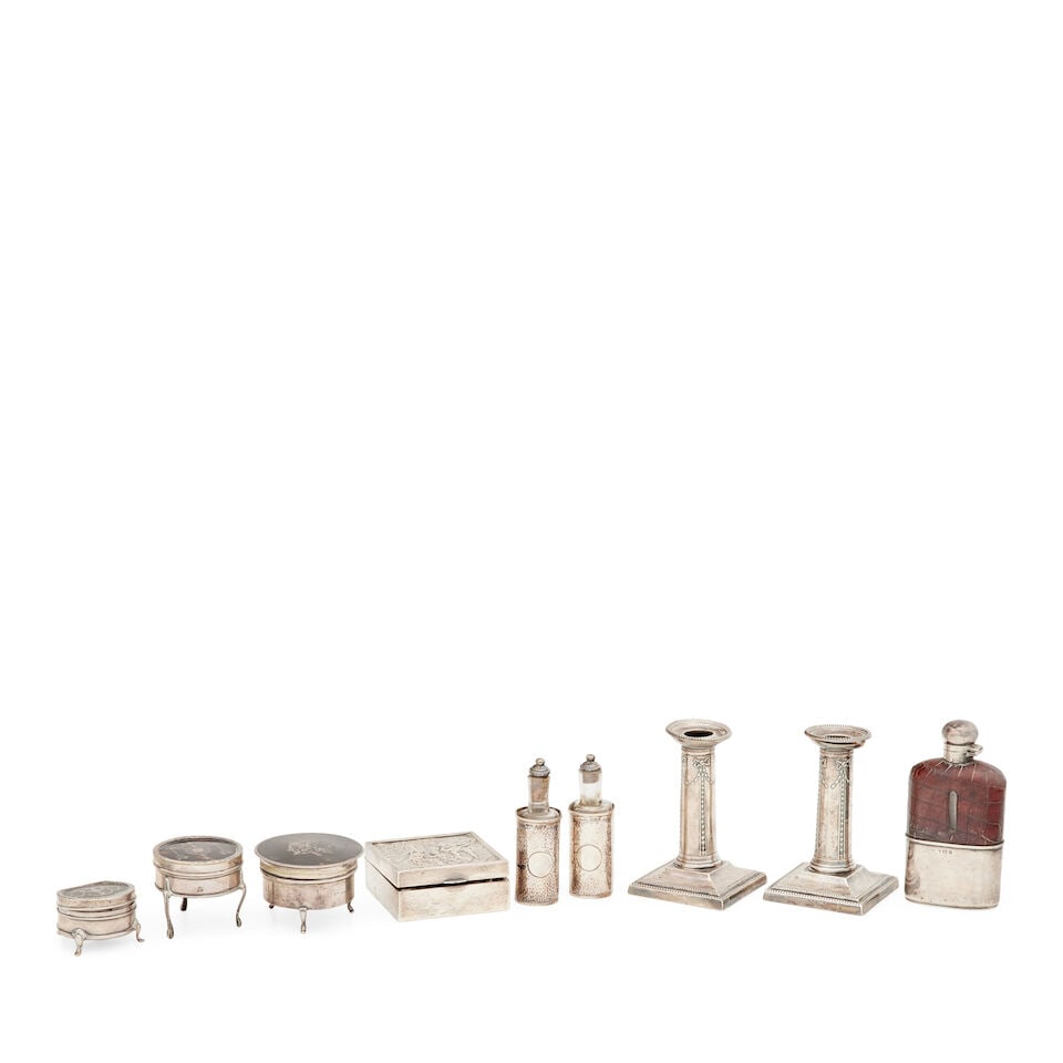 A collection of silver items various makers and dates (9): A collection of silver items various makers and dates Comprising a pair of desk candlesticks, Thomas Bradbury and son, Sheffield, 1910, 12cm high, a spirit flask, Birmingham, 1904, with leather casing