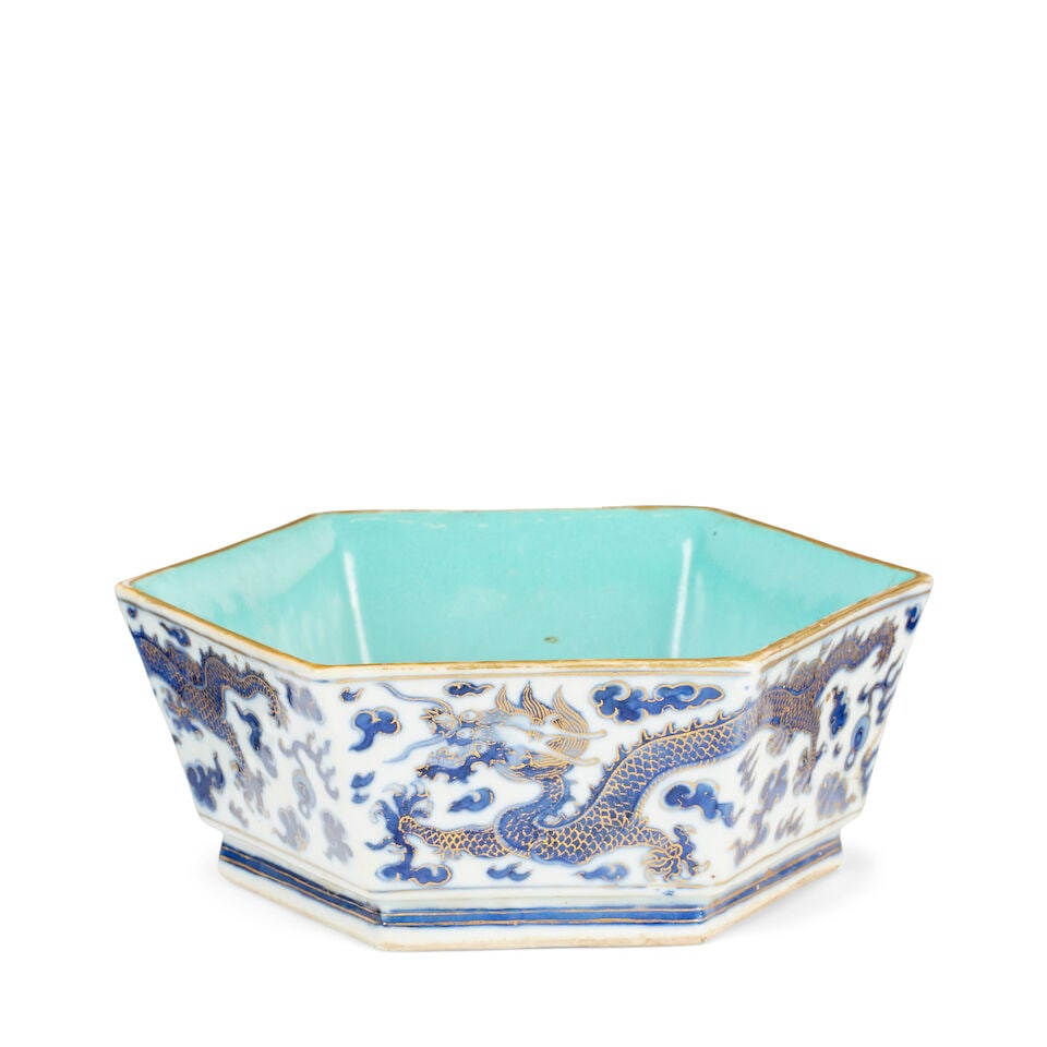 A hexagonal dragon bowl Duoguang red enamel seal mark: A hexagonal dragon bowl Duoguang red enamel seal mark With flaring sides, the exterior decorated in underglaze blue and gilt with three five toed dragons chasing pearls amidst clouds, with turquoise g