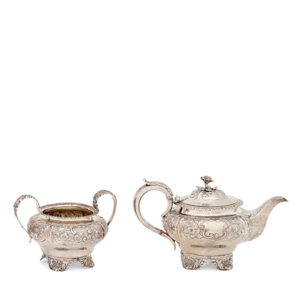 A George IV silver teapot and sugar bowl Probably by Hyam Hyams, London, 1826 (2): A George IV silver teapot and sugar bowl Probably by Hyam Hyams, London, 1826 On four foliate bracket feet, the inverted pear-shaped body embossed with flowers and scrolls on a matted ground, centred 