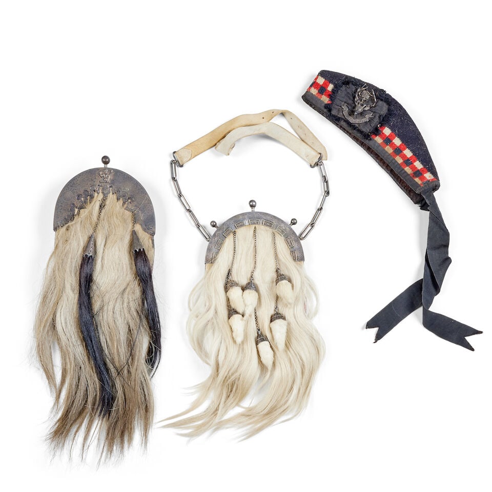 A 20th century silver plated sporran: A 20th century silver plated sporran The arched cantle engraved with knotwork and applied zoomorphic designs in rectangular tablets, with three finals, the bag faced in horsehair with six tassels,