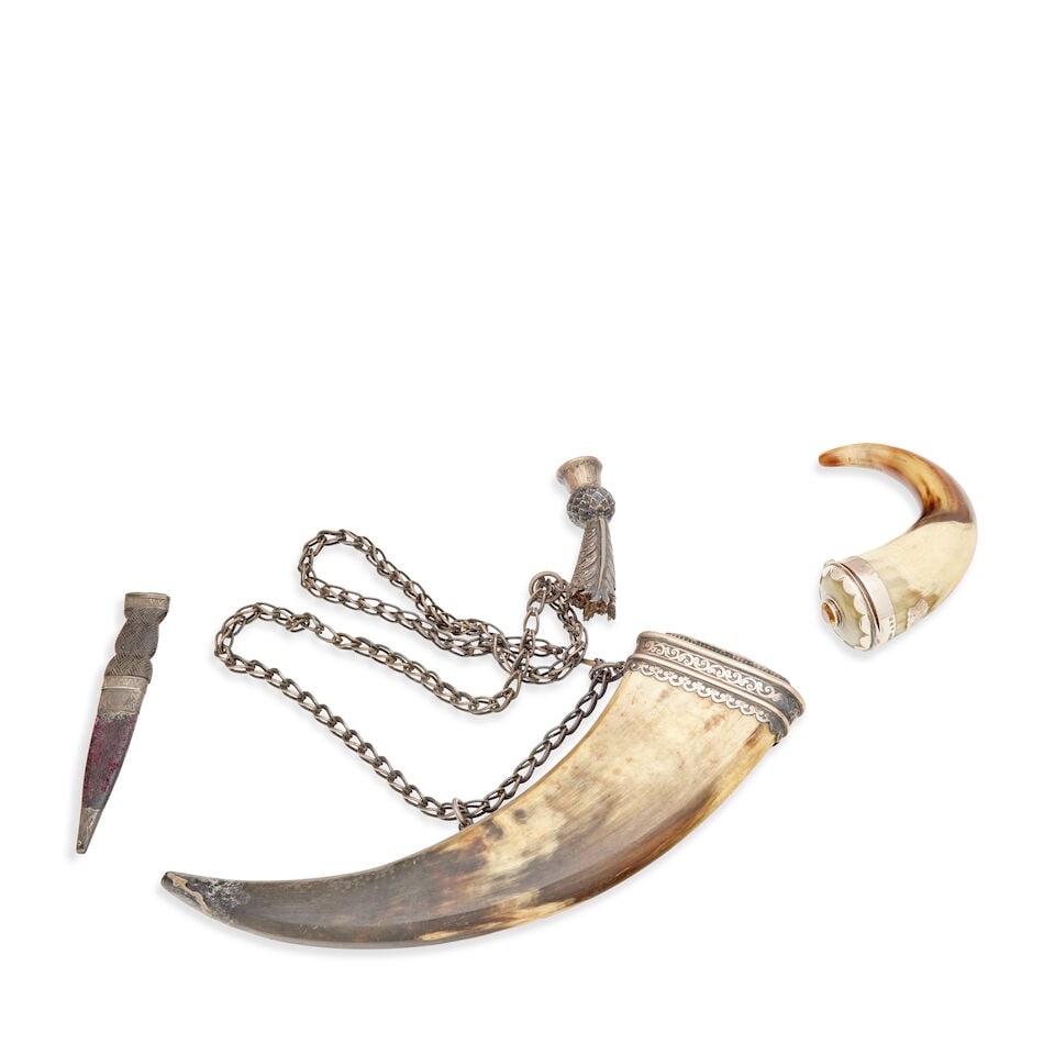 A silver-mounted dress powder flask Mid 19th century (3): A silver-mounted dress powder flask Mid 19th century The flattened horn with scroll-engraved neck mount set with a backed crystal, with thistle terminal set with a backed crystal, 30.5cm long, a