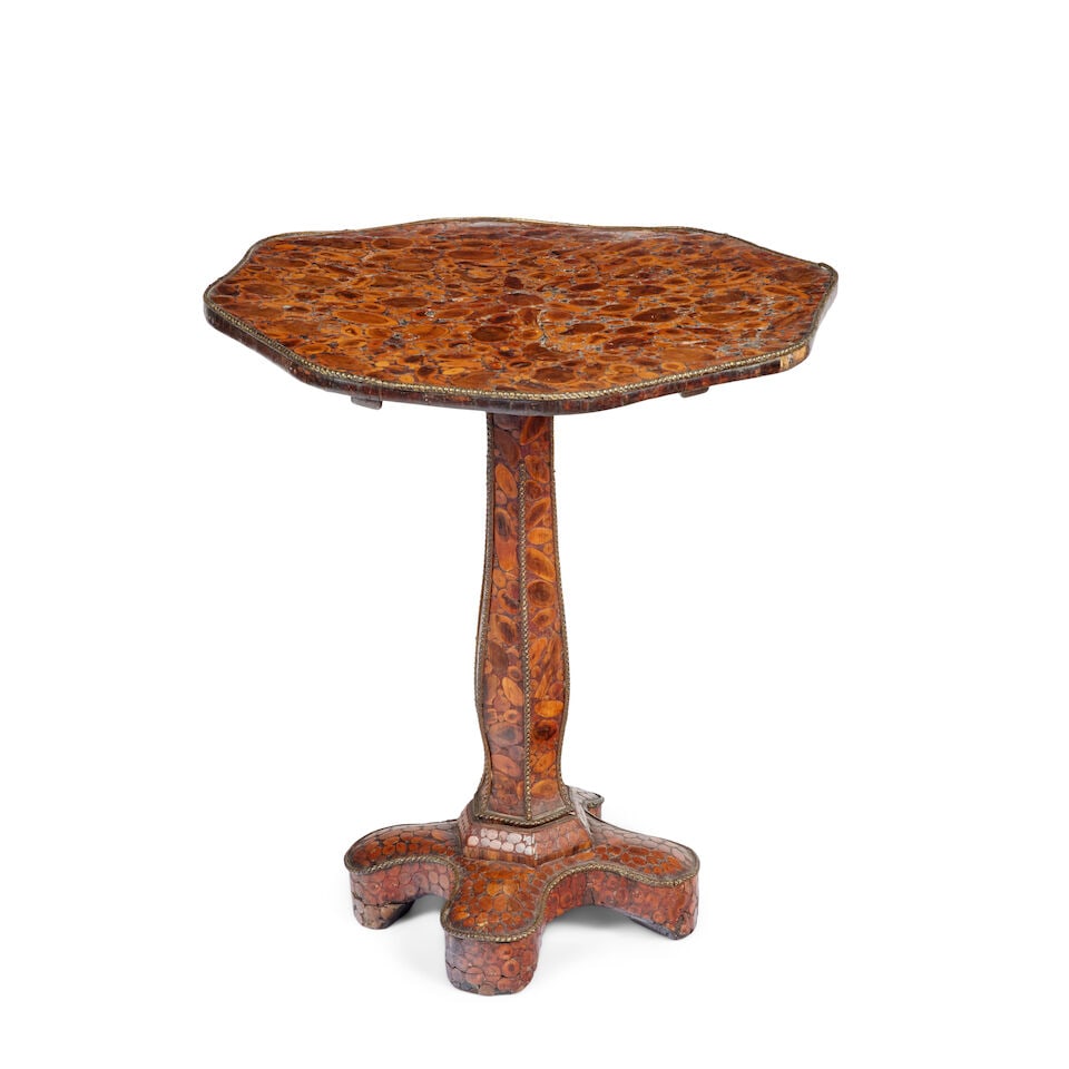 A 19th century laburnum oyster veneered occasional table: A 19th century laburnum oyster veneered occasional table The hinged shaped top with gilt metal edge, raised on a shaped hexagonal column, shaped base with block feet, 60cm in diameter, 66cm high (23