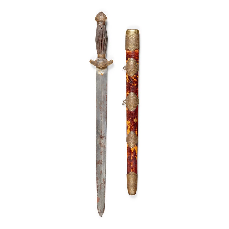 A late 19th/early 20th century Chinese jian broadsword: A late 19th/early 20th century Chinese jian broadsword The double edged blade, brass cast hilt and carved wooden grip, contained within its wooden tortoiseshell covered scabbard with twin suspension