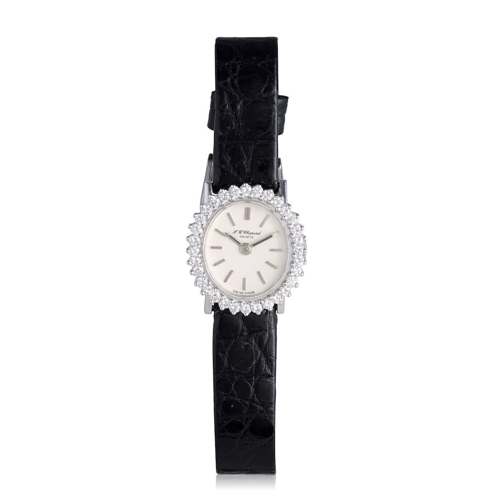 Chopard. A lady's 18K white gold diamond set manual wind wristwatch Ref: 7707/5025, Circa 1990: Chopard. A lady's 18K white gold diamond set manual wind wristwatch Reference: 7707/5025 Date: Circa 1990 Movement: 17-jewel manual wind Dial: Silvered Case: Brushed and polished oval form, diamond